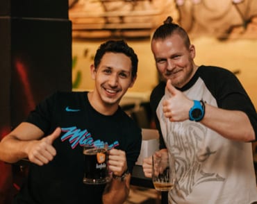 Two team members posing with their drinks